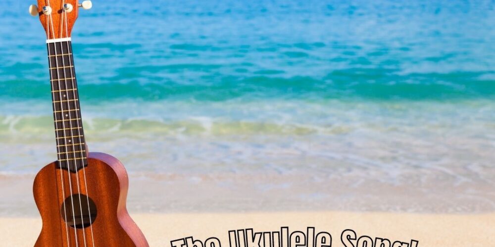 A ukulele on a beach. Text reads: The Ukulele Song followed by the writer's name: ROSE OYAMOT RODRIGUEZ