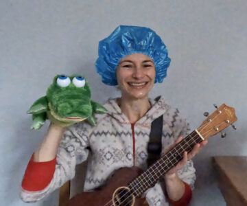 Ms. Christina in shower cap with ukulele and alligator puppet