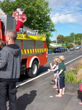 Rural fire truck, with a Santa on the back. 